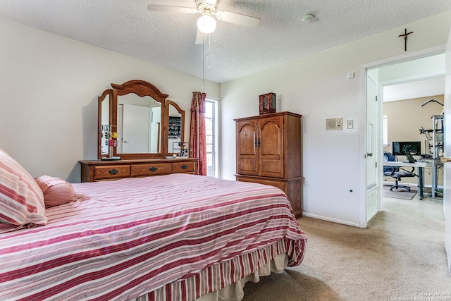 bedroom featuring ceiling fan, baseboards, a textured ceiling, and light colored carpet