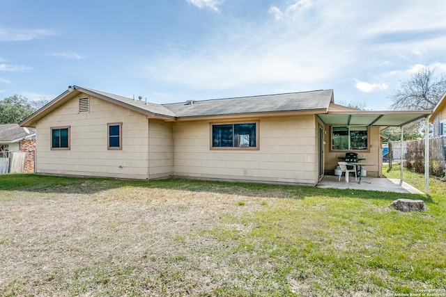 back of house featuring a yard, a patio area, and fence