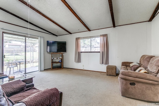 carpeted living room with lofted ceiling with beams, a healthy amount of sunlight, baseboards, and a textured ceiling