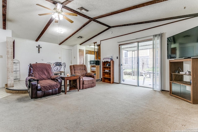 living area with vaulted ceiling with beams, a textured ceiling, carpet, and visible vents