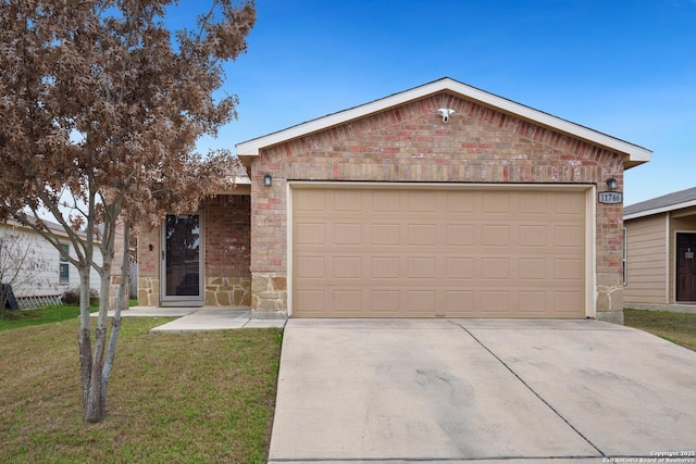 ranch-style home featuring a front yard, concrete driveway, brick siding, and an attached garage