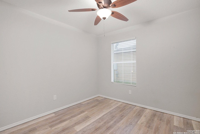 empty room with a ceiling fan, light wood-style flooring, and baseboards