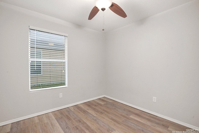 unfurnished room with ceiling fan, baseboards, and wood finished floors