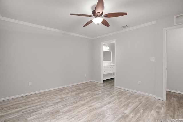 unfurnished room with baseboards, visible vents, and wood finished floors