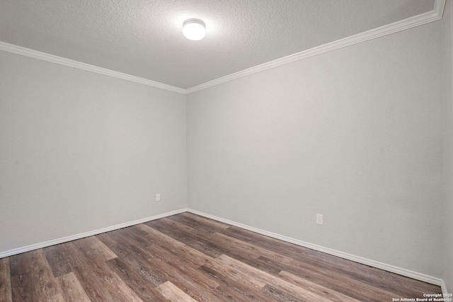 unfurnished room featuring crown molding, baseboards, and dark wood-style flooring