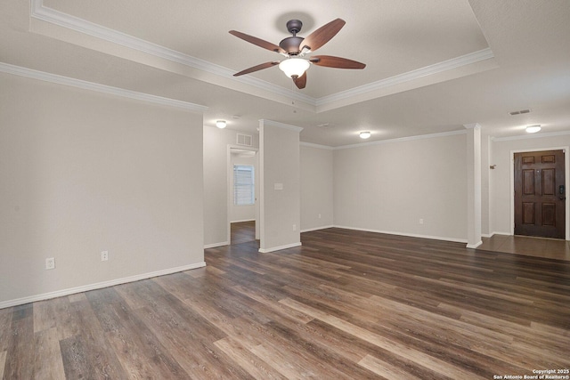 spare room featuring baseboards, a raised ceiling, dark wood-style floors, ceiling fan, and ornamental molding