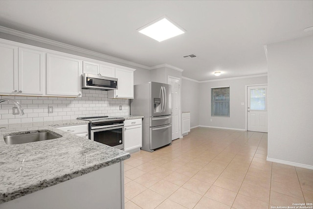 kitchen with crown molding, appliances with stainless steel finishes, backsplash, and a sink