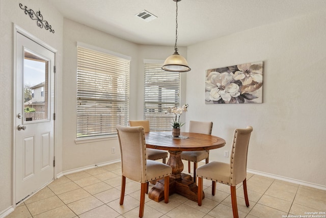 dining space featuring light tile patterned flooring, baseboards, and visible vents