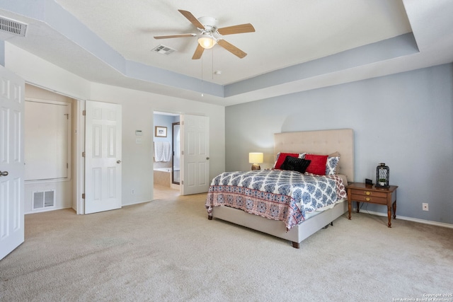 bedroom featuring visible vents, a raised ceiling, and carpet floors