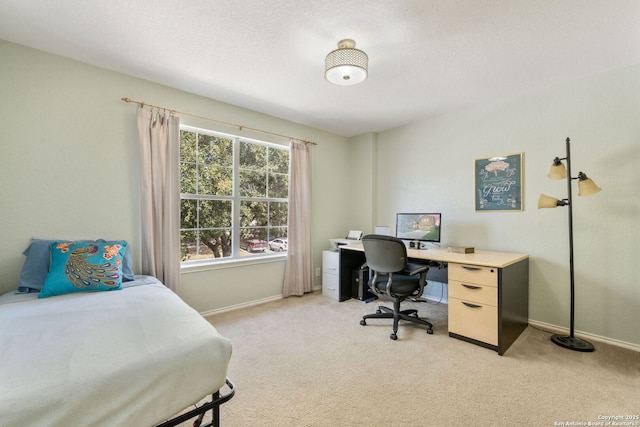 bedroom with light colored carpet and baseboards