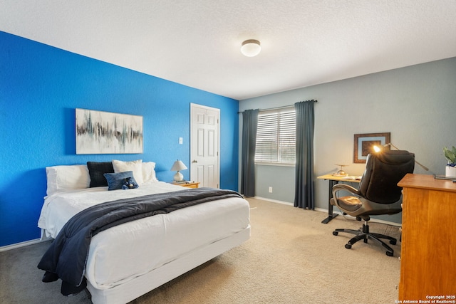 bedroom featuring a textured ceiling, baseboards, and carpet floors