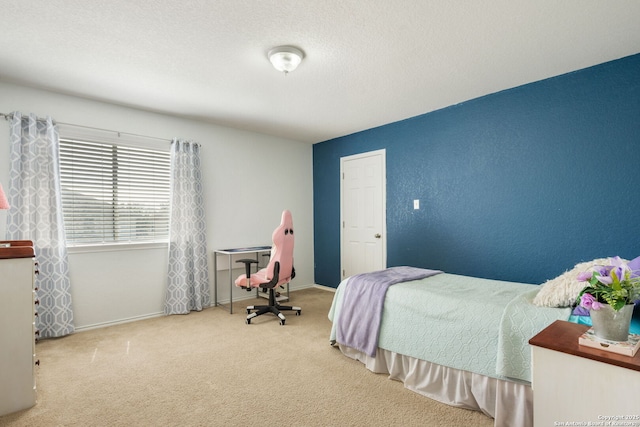 bedroom featuring baseboards, carpet floors, and a textured ceiling