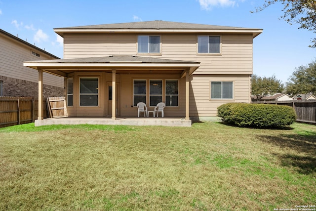 rear view of house featuring a patio area, a lawn, and a fenced backyard