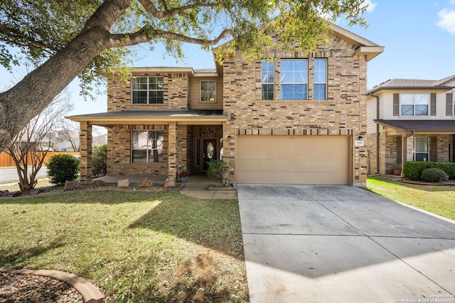 traditional-style house featuring concrete driveway, an attached garage, brick siding, and a front lawn