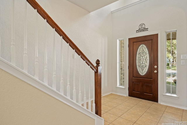 entryway featuring stairs and tile patterned flooring