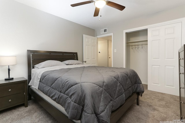 bedroom with light carpet, a ceiling fan, visible vents, and a closet