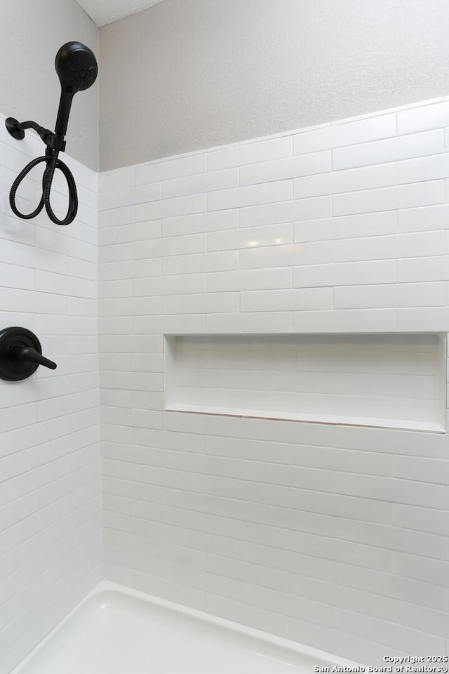 room details with a tile shower