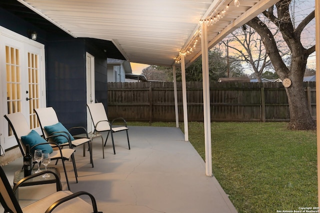 view of patio featuring french doors and fence