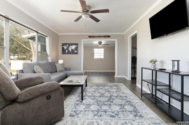 living room with ornamental molding, wood finished floors, and baseboards