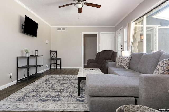 living room featuring visible vents, dark wood finished floors, and crown molding