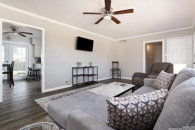 living room featuring crown molding, dark wood finished floors, visible vents, and baseboards