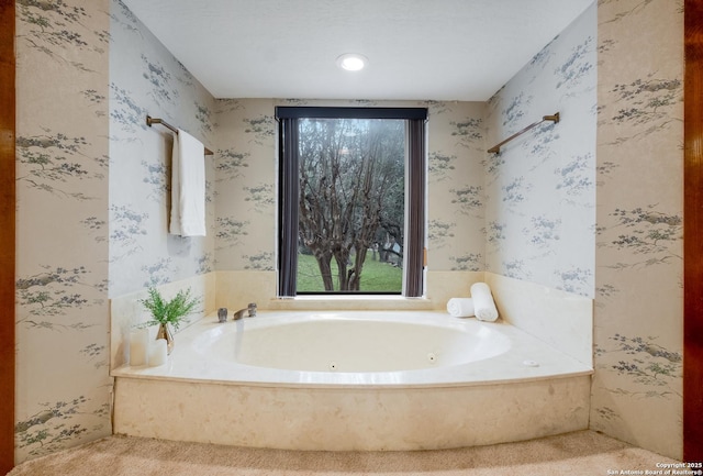 full bath with a tub with jets and wallpapered walls