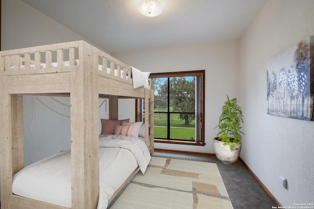 bedroom featuring carpet floors and baseboards