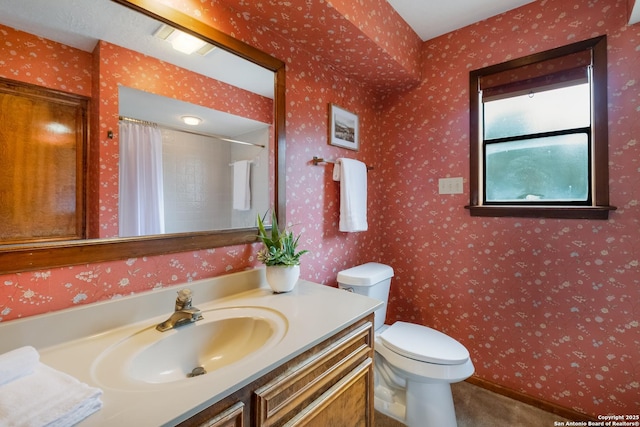 bathroom featuring toilet, wallpapered walls, a shower with curtain, and vanity