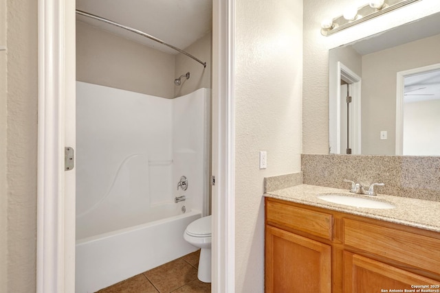 full bath with shower / bath combination, vanity, toilet, and tile patterned floors