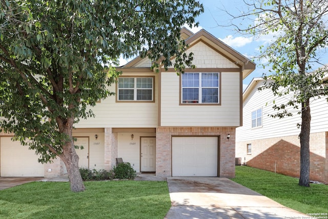 view of front of home with concrete driveway, an attached garage, cooling unit, a front lawn, and brick siding