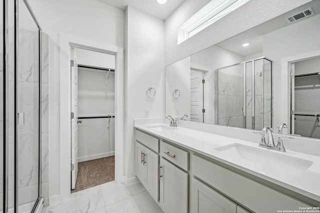 full bath featuring visible vents, a marble finish shower, a sink, and marble finish floor