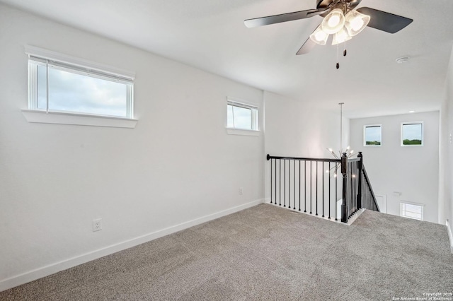 unfurnished room featuring baseboards, carpet, and ceiling fan