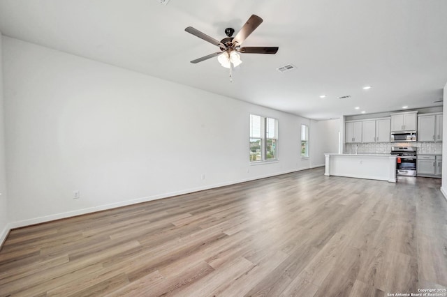 unfurnished living room with visible vents, baseboards, ceiling fan, recessed lighting, and light wood finished floors