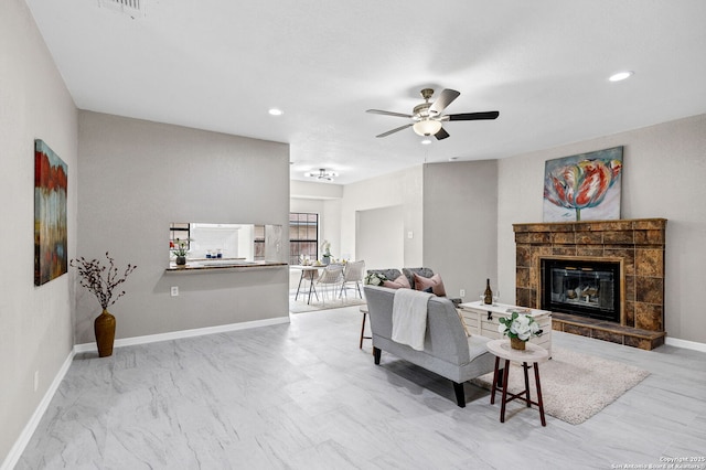 living room featuring recessed lighting, a fireplace, baseboards, and ceiling fan