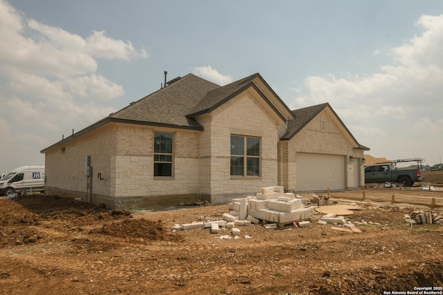5810 Provo Pl, San Antonio, TX 78263 - view of property exterior with stone siding, brick siding, a shingled roof, and an attached garage