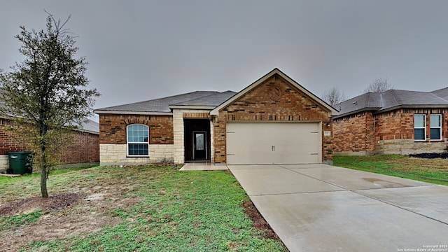 view of front of property featuring a garage, a front yard, concrete driveway, and brick siding