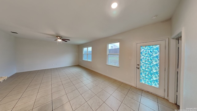 empty room featuring ceiling fan and light tile patterned floors