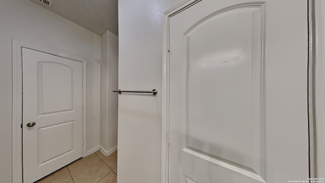 bathroom featuring tile patterned flooring and baseboards