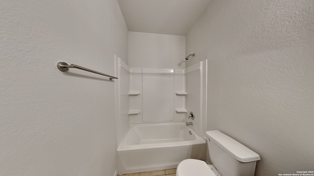 full bath featuring toilet, shower / bathing tub combination, and a textured wall