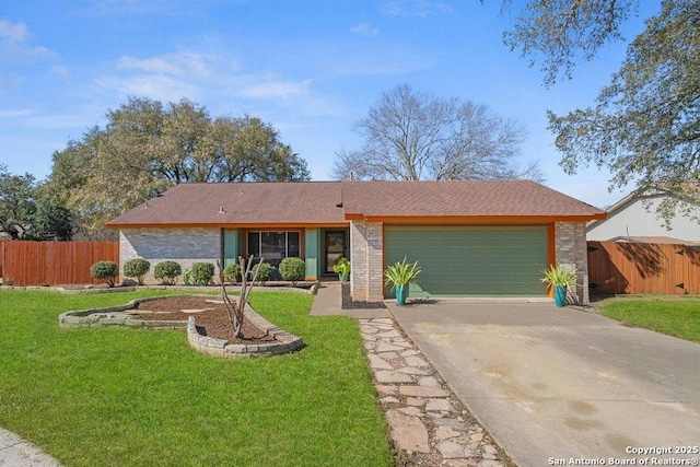 view of front of property with concrete driveway, fence, a front lawn, and an attached garage