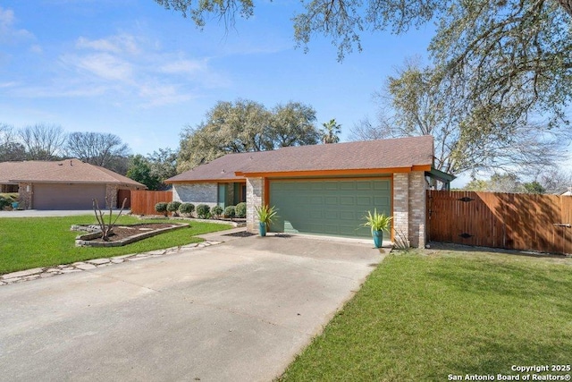 view of front of house featuring a garage, driveway, a front lawn, and fence