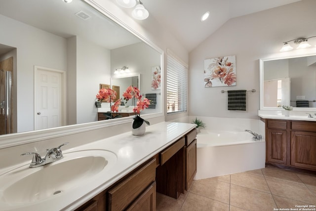 bathroom featuring two vanities, a sink, tile patterned flooring, vaulted ceiling, and a bath