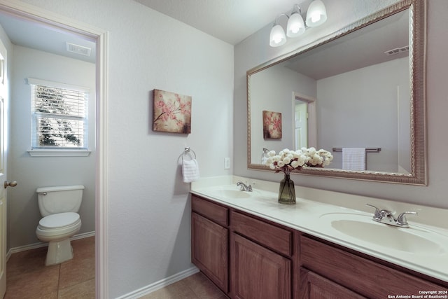 full bathroom featuring double vanity, visible vents, a sink, and tile patterned floors