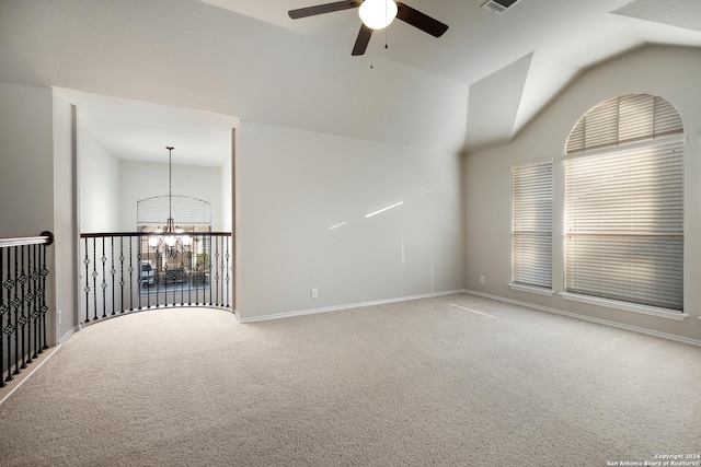 spare room featuring visible vents, baseboards, carpet, high vaulted ceiling, and ceiling fan with notable chandelier