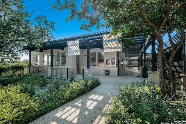 view of community with a gate, fence, and a pergola