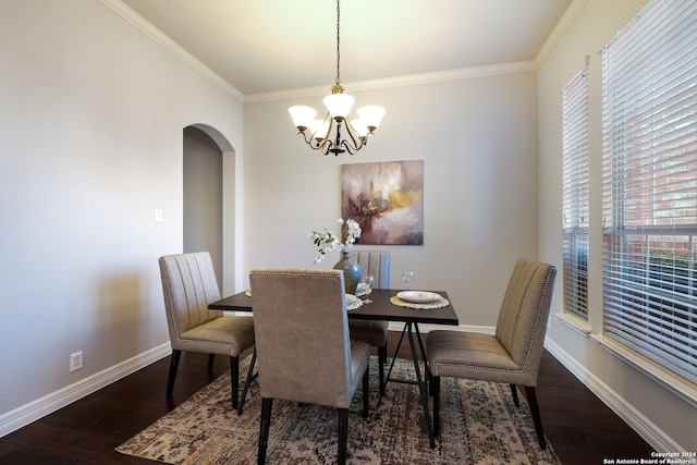 dining space with arched walkways, baseboards, and wood finished floors