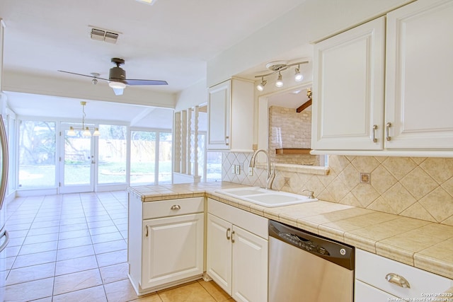 kitchen with light tile patterned floors, tasteful backsplash, visible vents, stainless steel dishwasher, and a sink