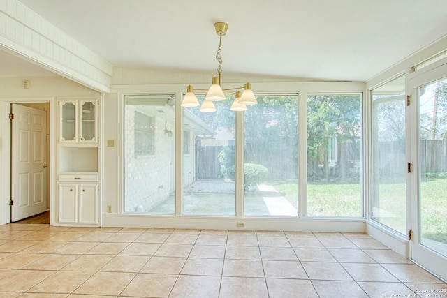 unfurnished sunroom featuring a notable chandelier