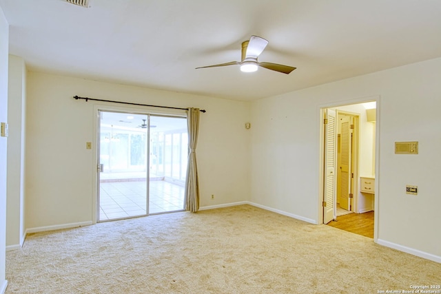 empty room with a ceiling fan, carpet, and baseboards