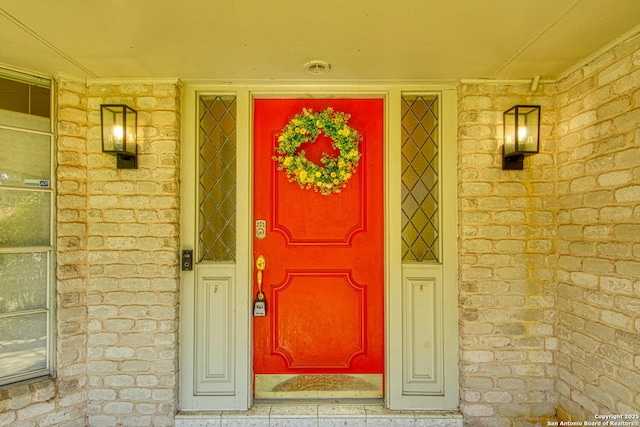 property entrance featuring stone siding and covered porch